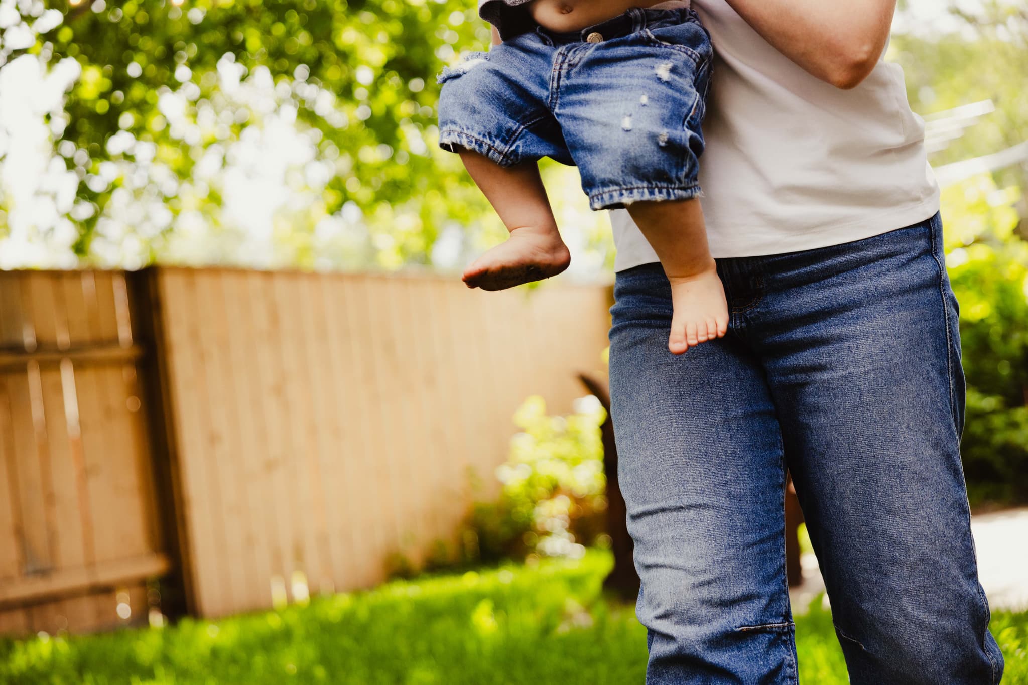A parent holding a young child close at home in Lethbridge