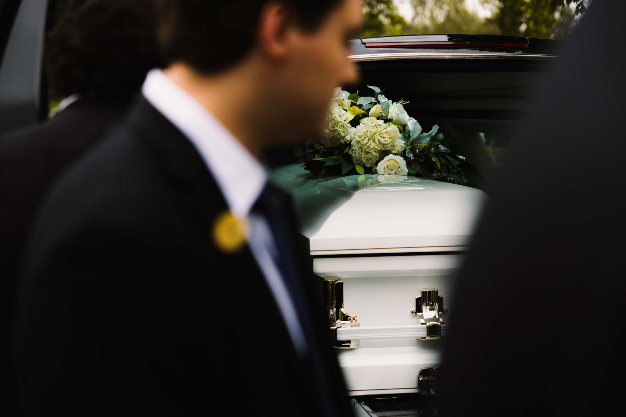 Dignified funeral service in Lethbridge — a white casket with a floral tribute at Martin Brothers