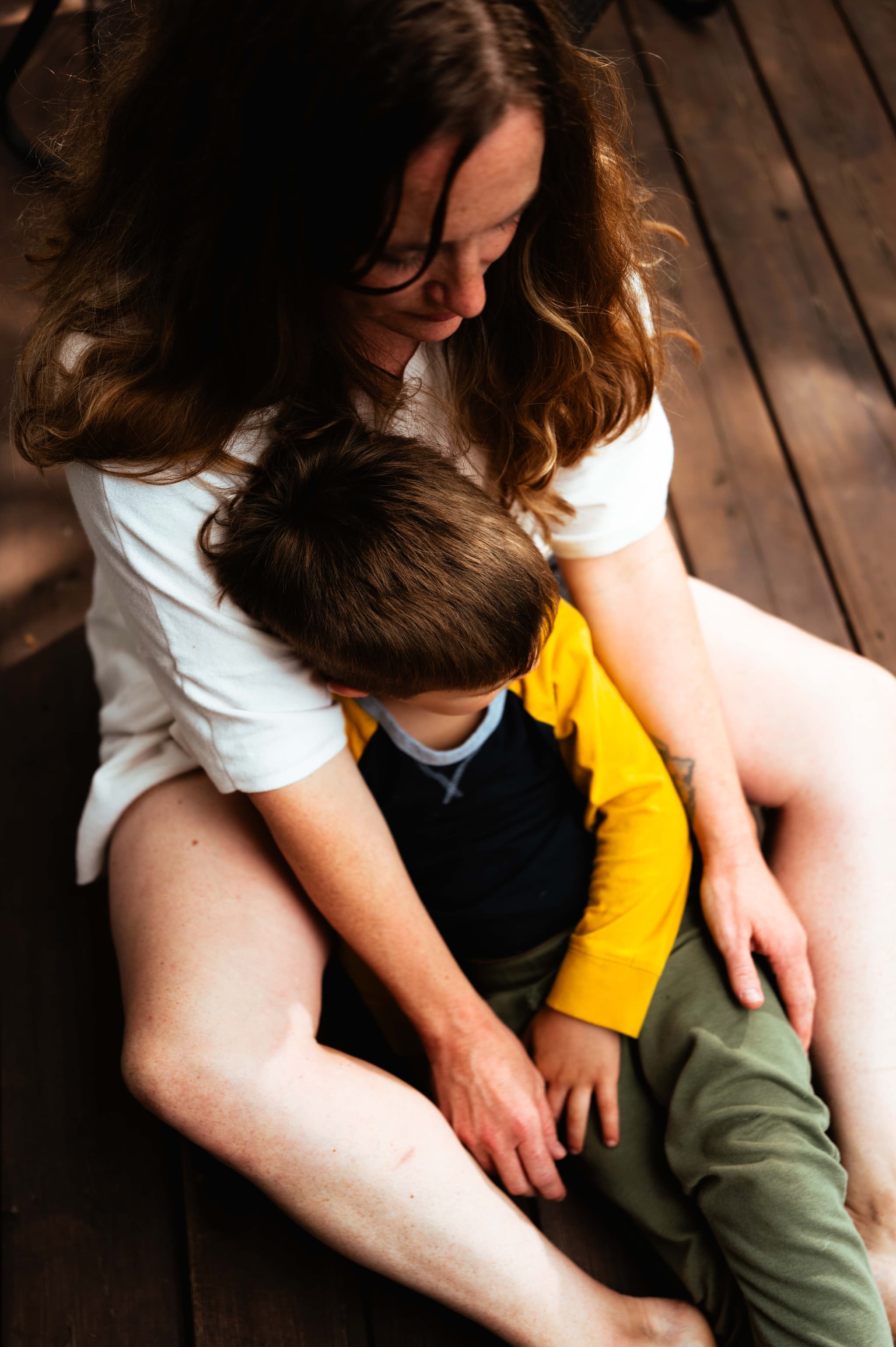 A mother holding her young son close